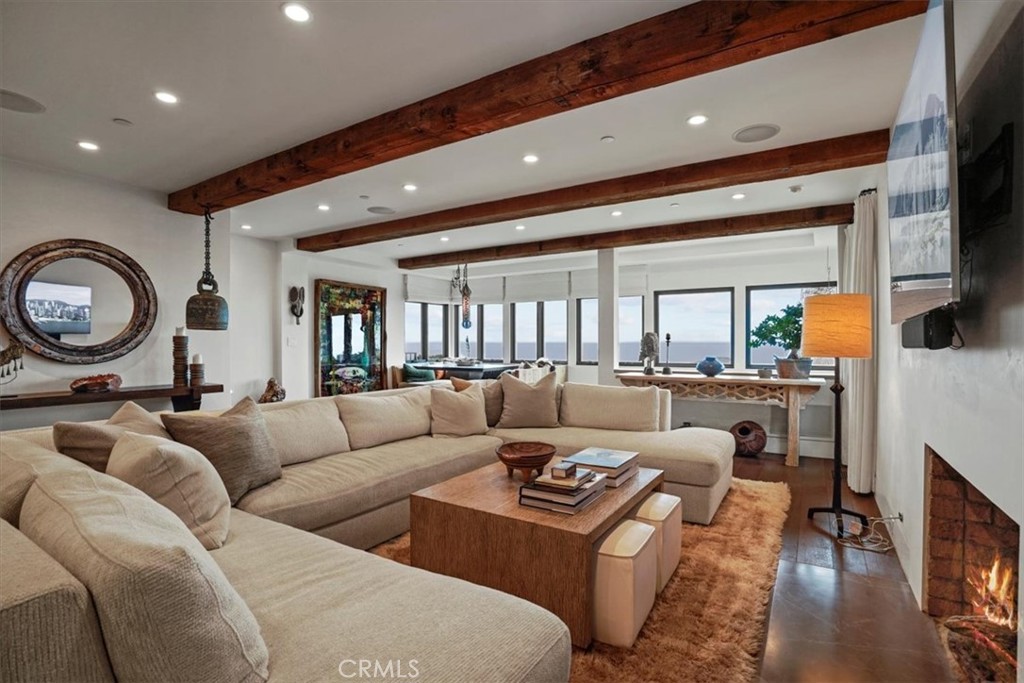 a living room with furniture a large window and a rug