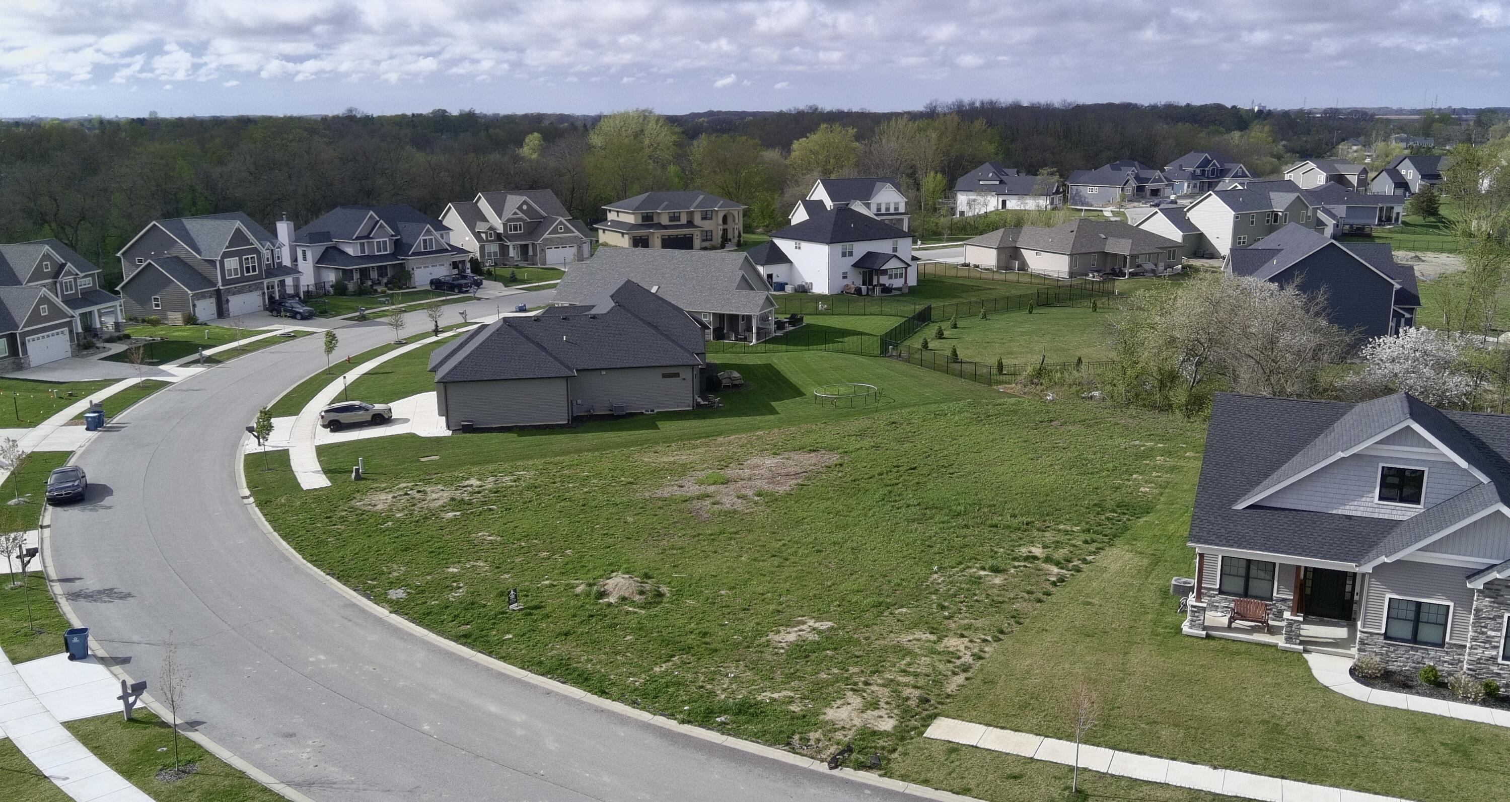 an aerial view of a house with a garden and lake view