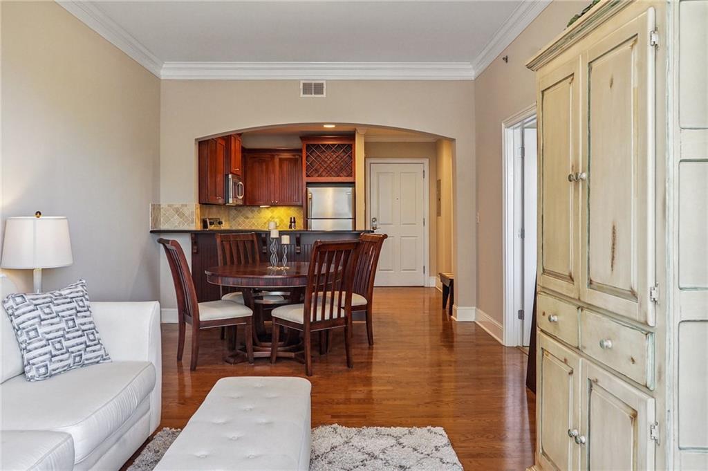 a view of a dining room with furniture and wooden floor