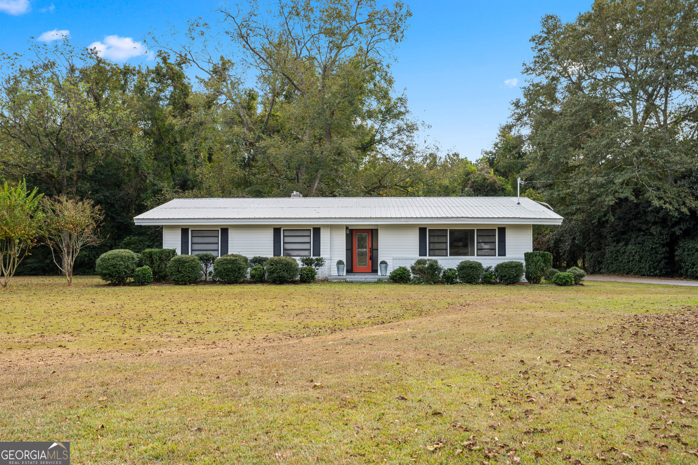 a front view of a house with a garden