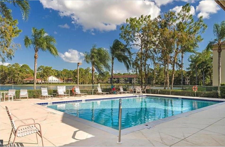 a view of swimming pool with outdoor seating