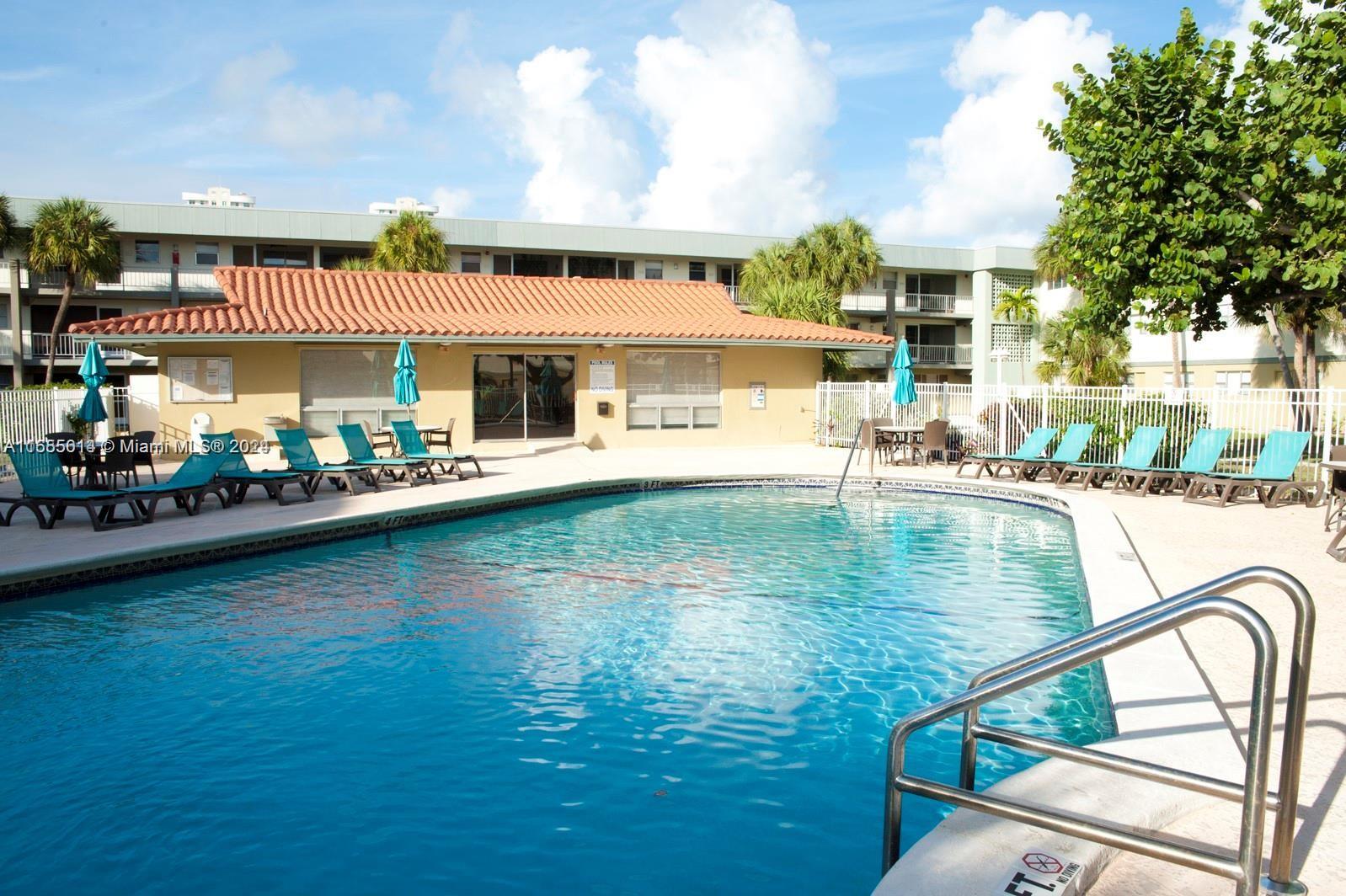 a view of a swimming pool with outdoor seating