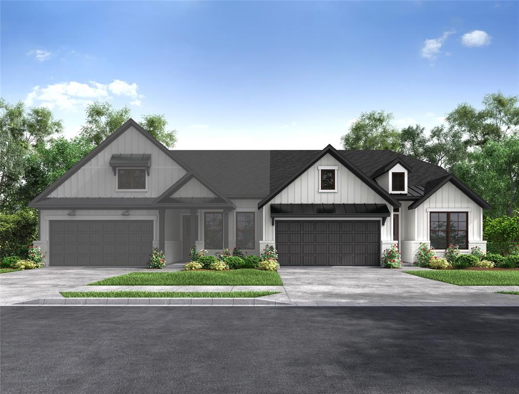 a front view of a house with a garden and garage