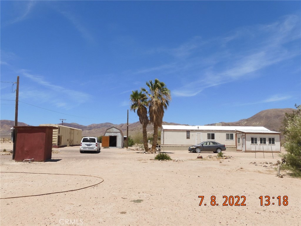 Front of property.  From left to right, the well shed, Boxcar, storage shed, mobile home.