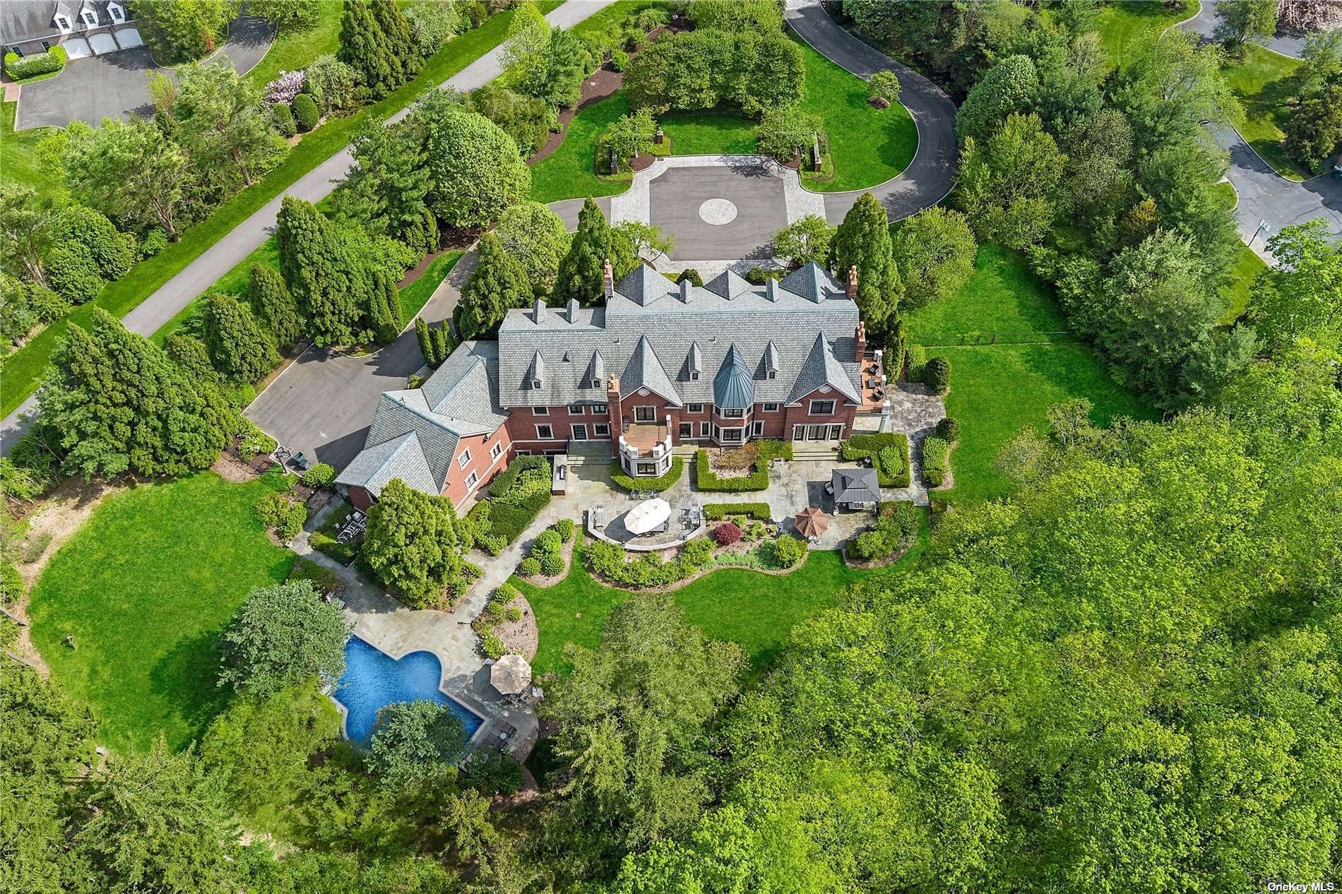 an aerial view of a house with garden space and street view