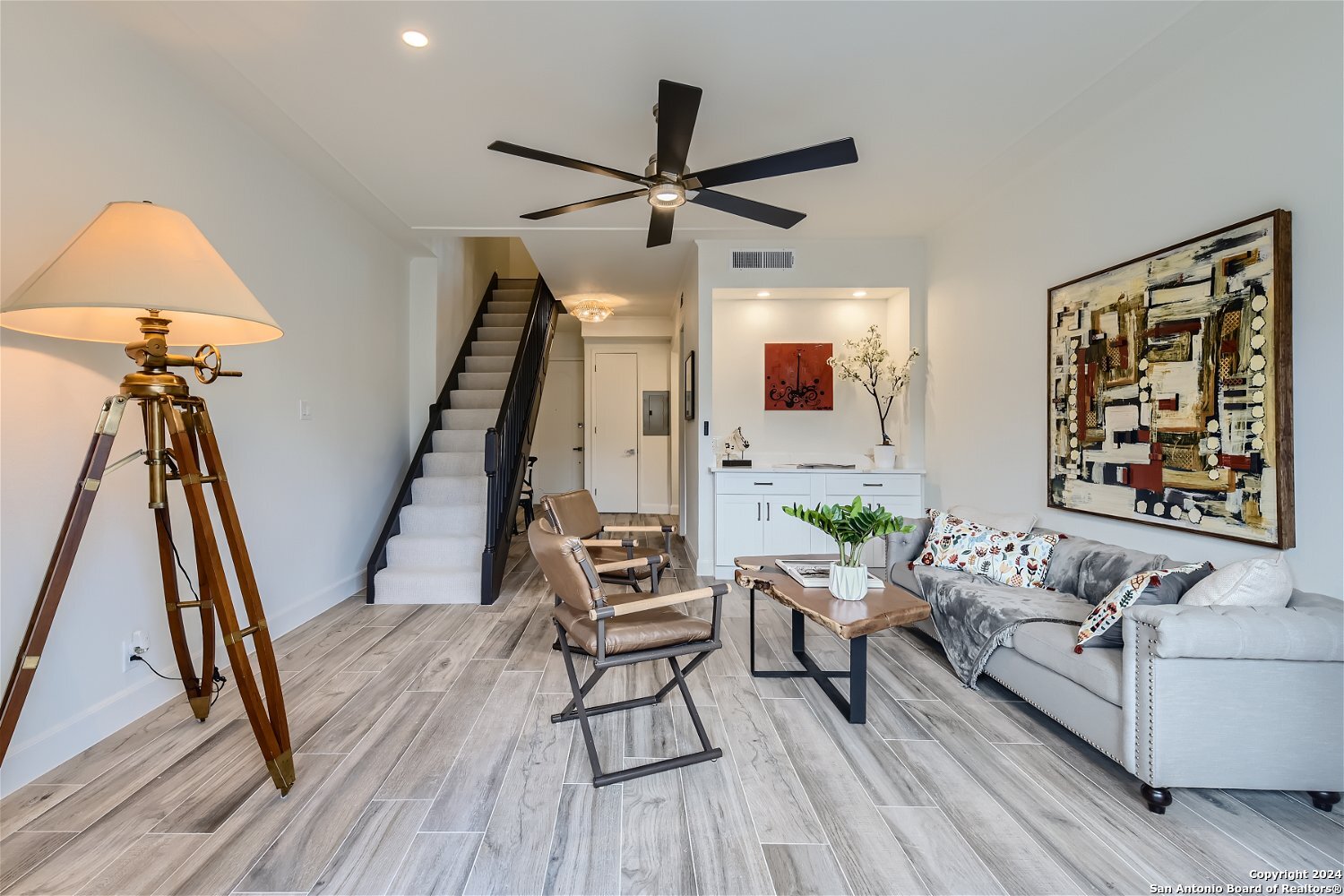 a living room with furniture and a wooden floor