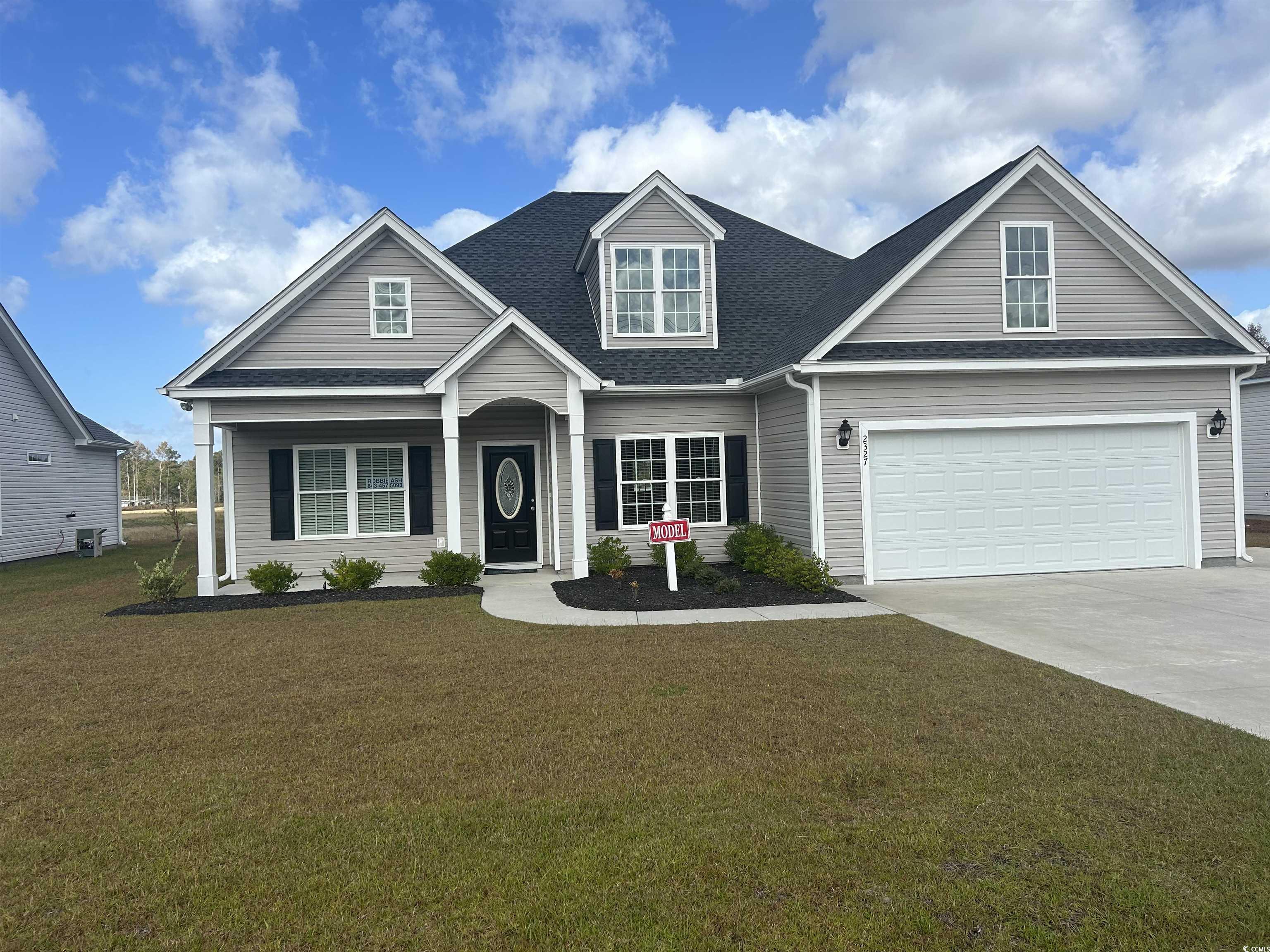 View of front facade featuring a garage and a fron