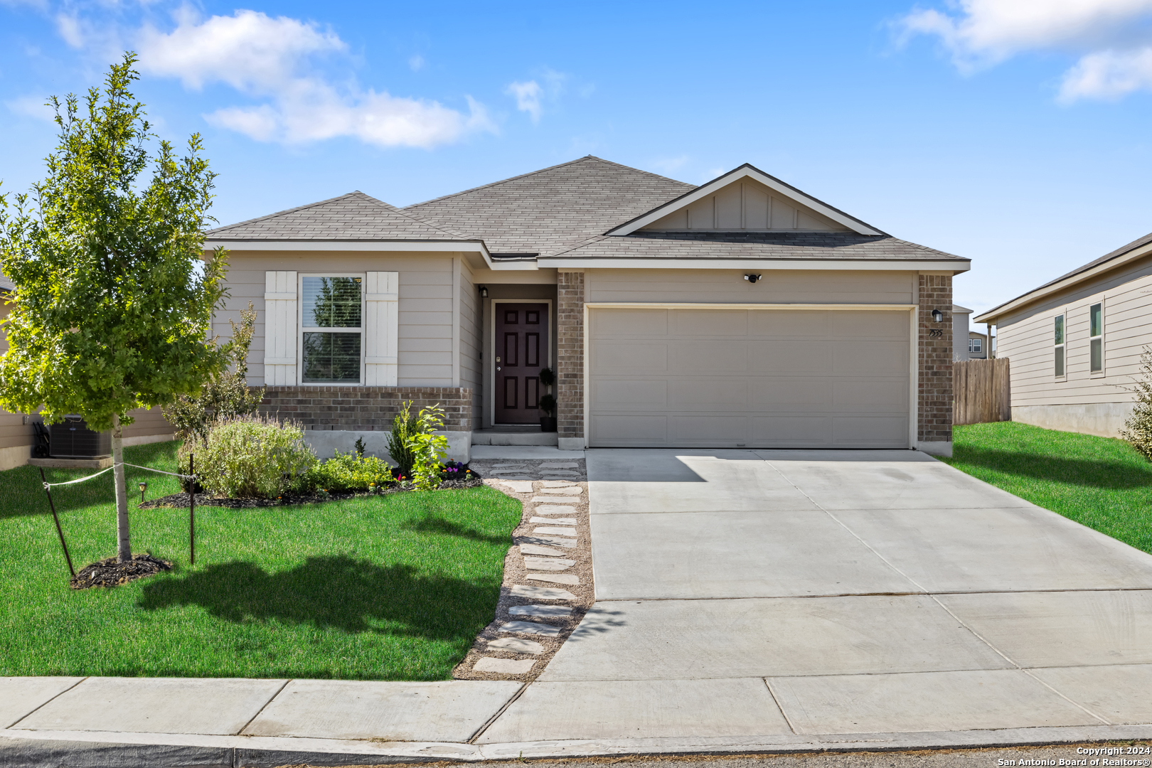 a front view of a house with a yard