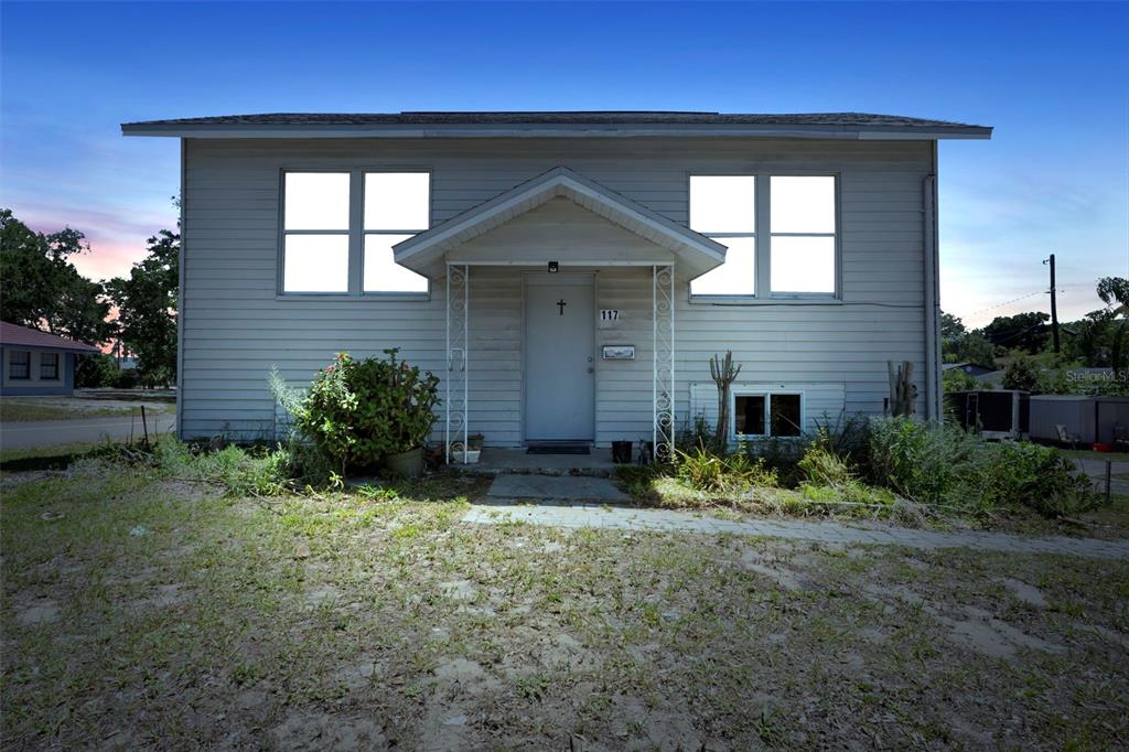 a view of house with yard