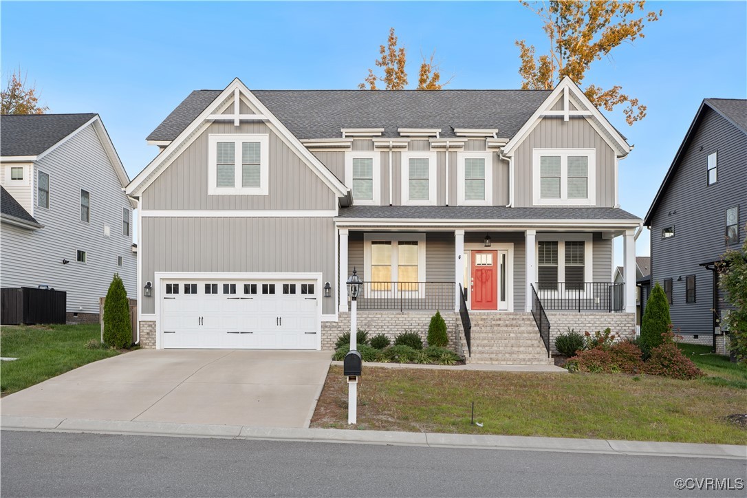 Craftsman-style home with covered porch, a front y