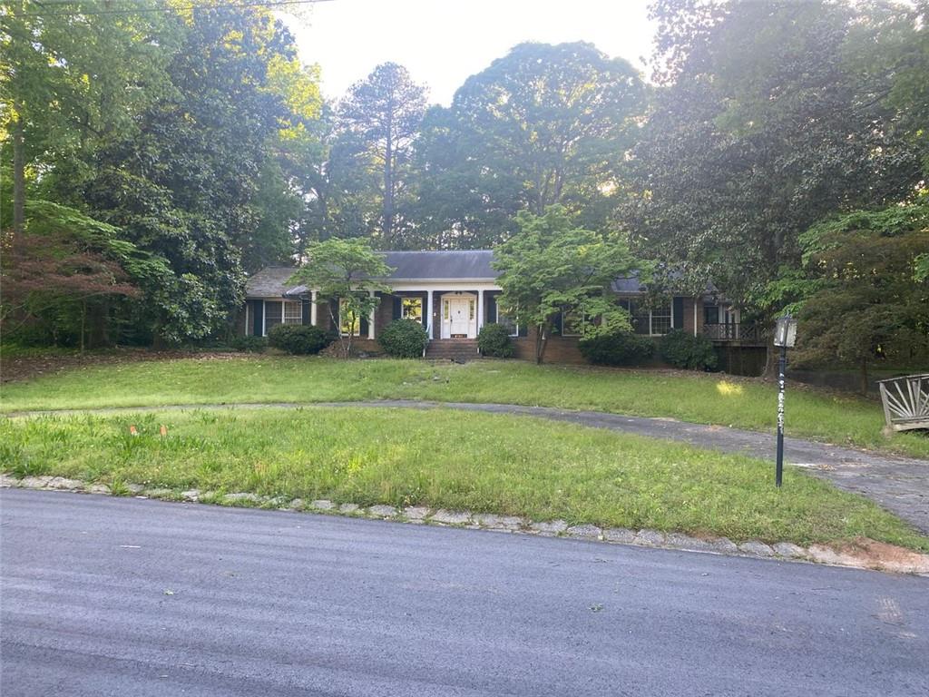 a front view of house with yard and green space