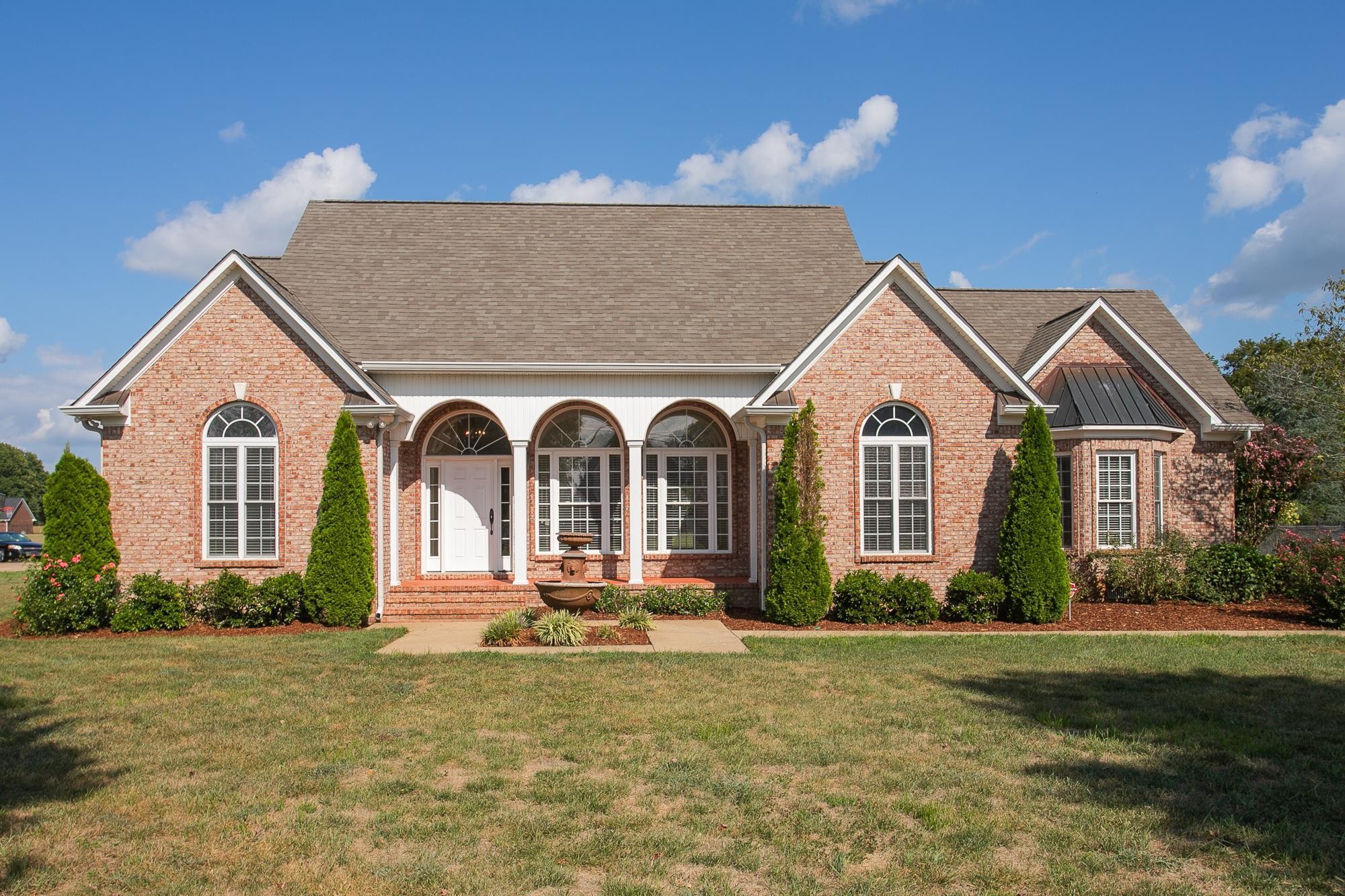 a front view of house with yard and green space