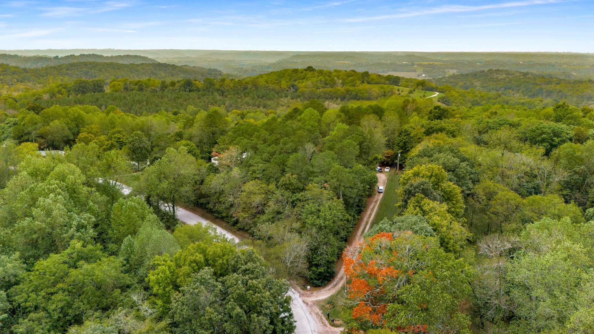 a view of an aerial view of residential houses with outdoor space and trees