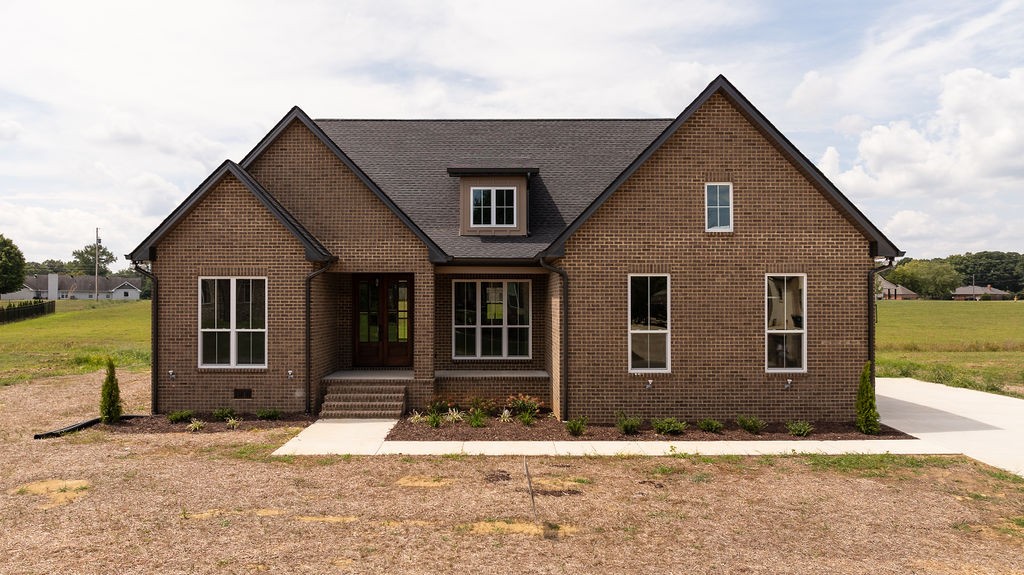 a front view of a house with a yard