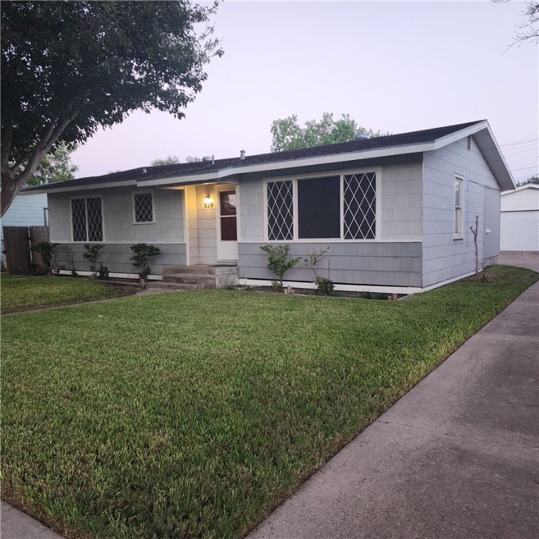 a front view of house with yard and green space