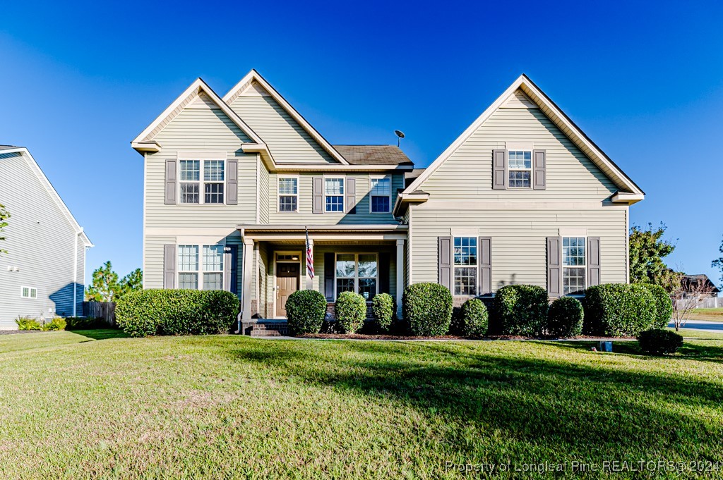 a front view of a house with a garden