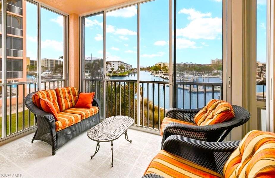 a balcony with furniture and a large window