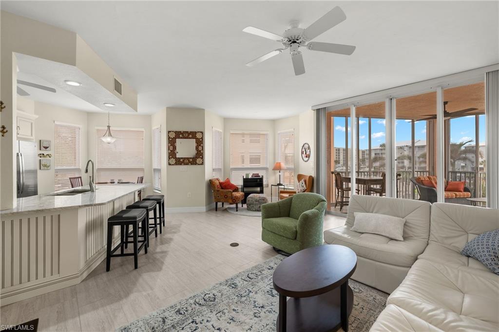 a living room with furniture a large window and a table