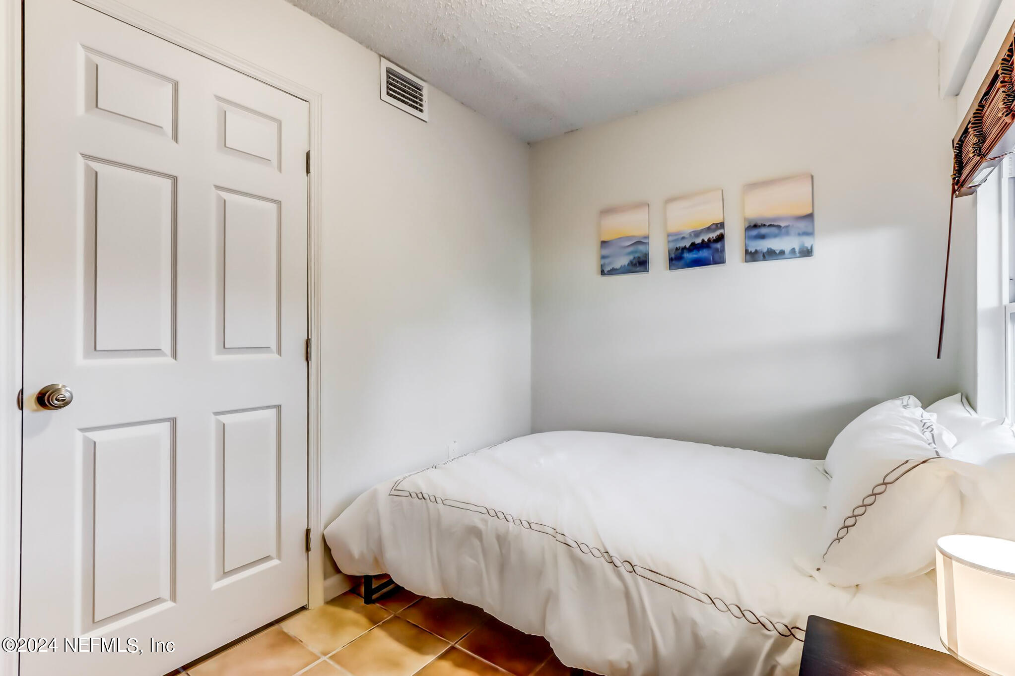 a bedroom with a bed and a window