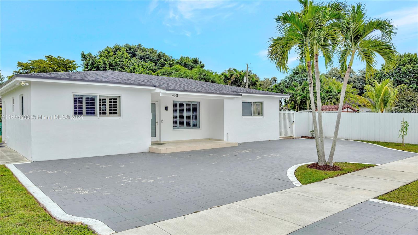 a view of a house with a backyard and a garage