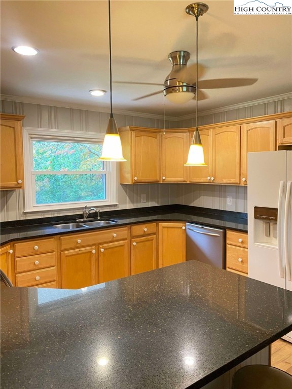 a kitchen with stainless steel appliances granite countertop a sink a stove and a wooden floors