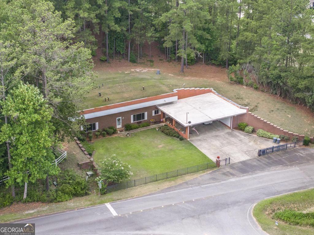 an aerial view of a house with a yard