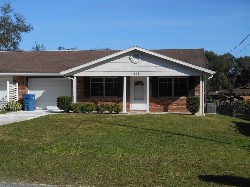 a view of a house with backyard porch and sitting area