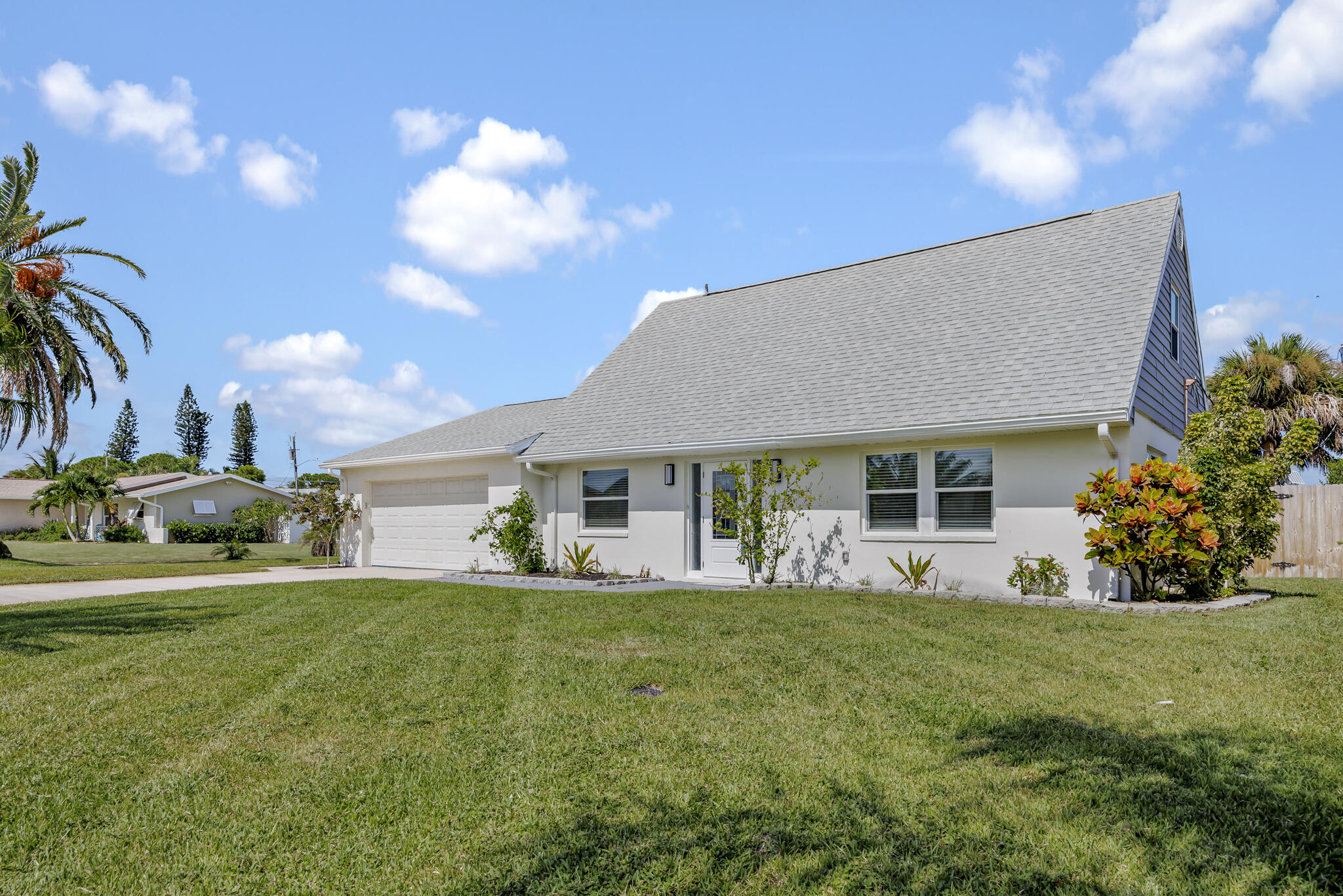 a view of a house with backyard and sitting area