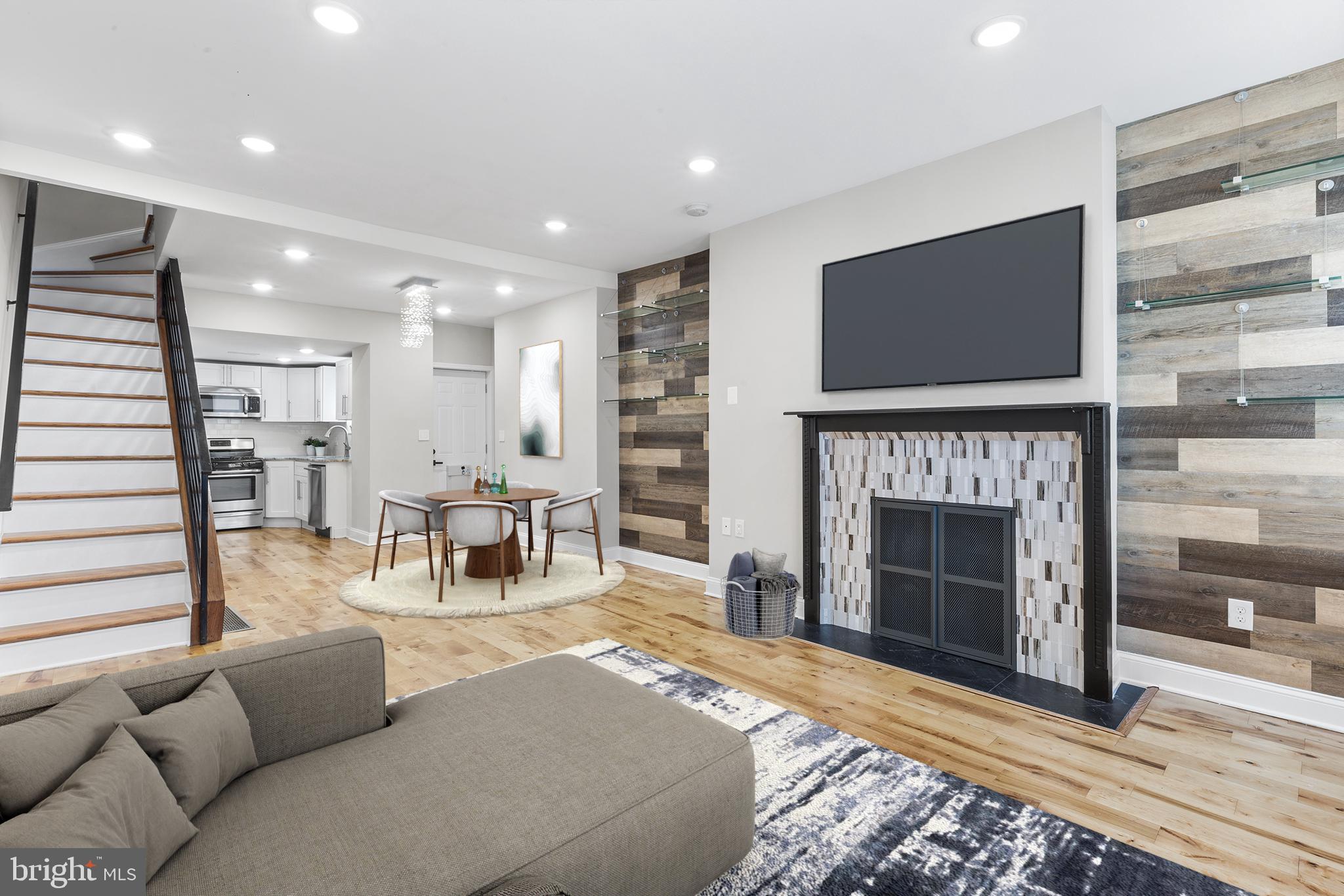 a living room with furniture a flat screen tv and a fireplace