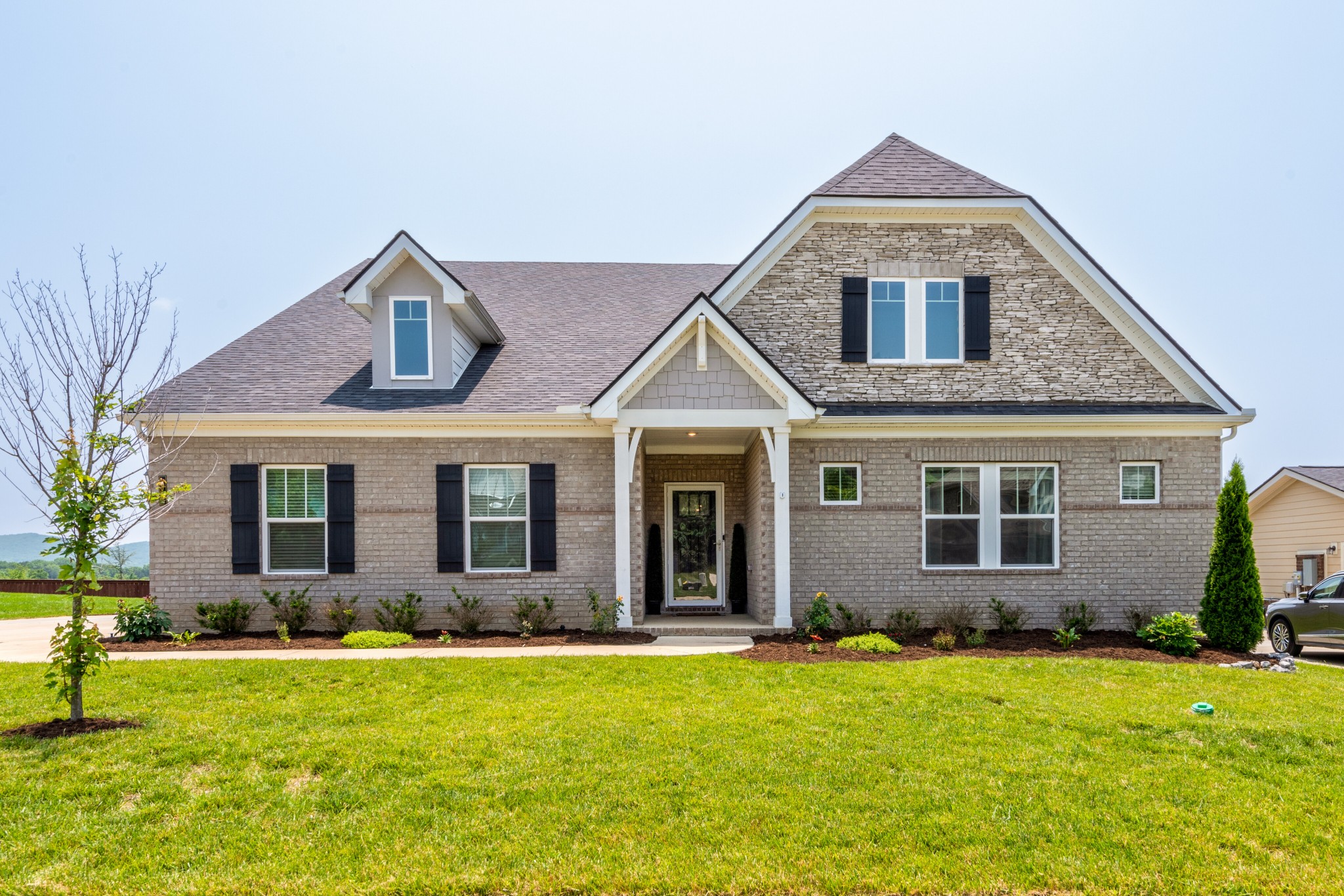 a front view of a house with a yard