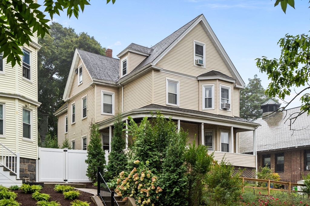 a front view of a house with plants