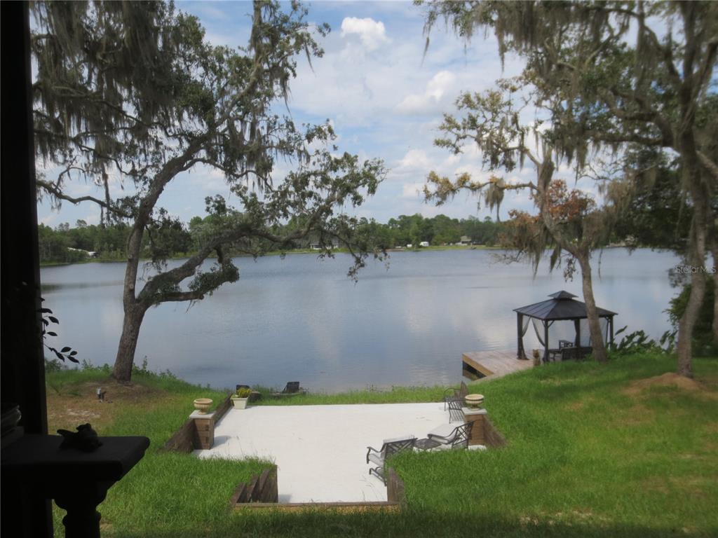 Expansive Lakefront terrace to floating doc and gazebo.