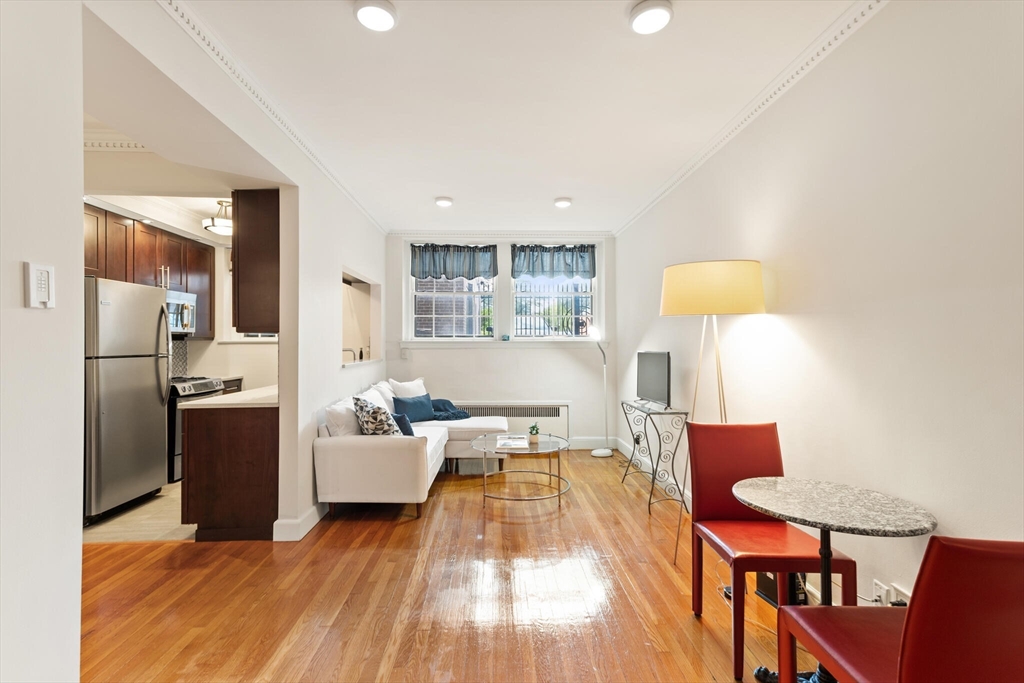 a living room with furniture and a kitchen island