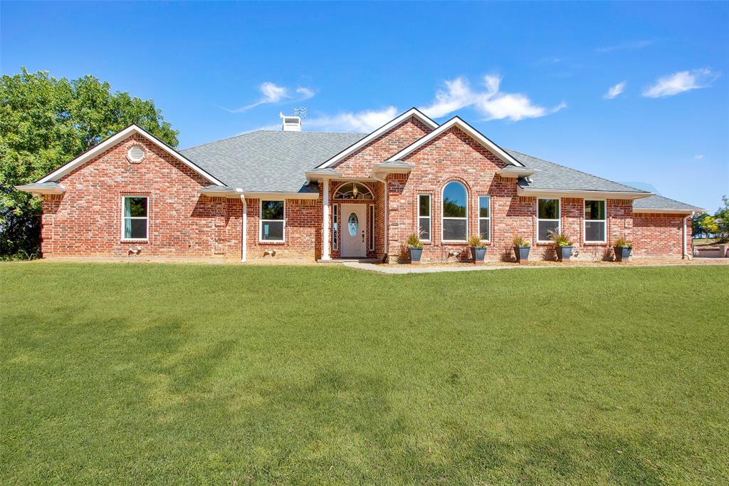 a front view of house with yard and green space