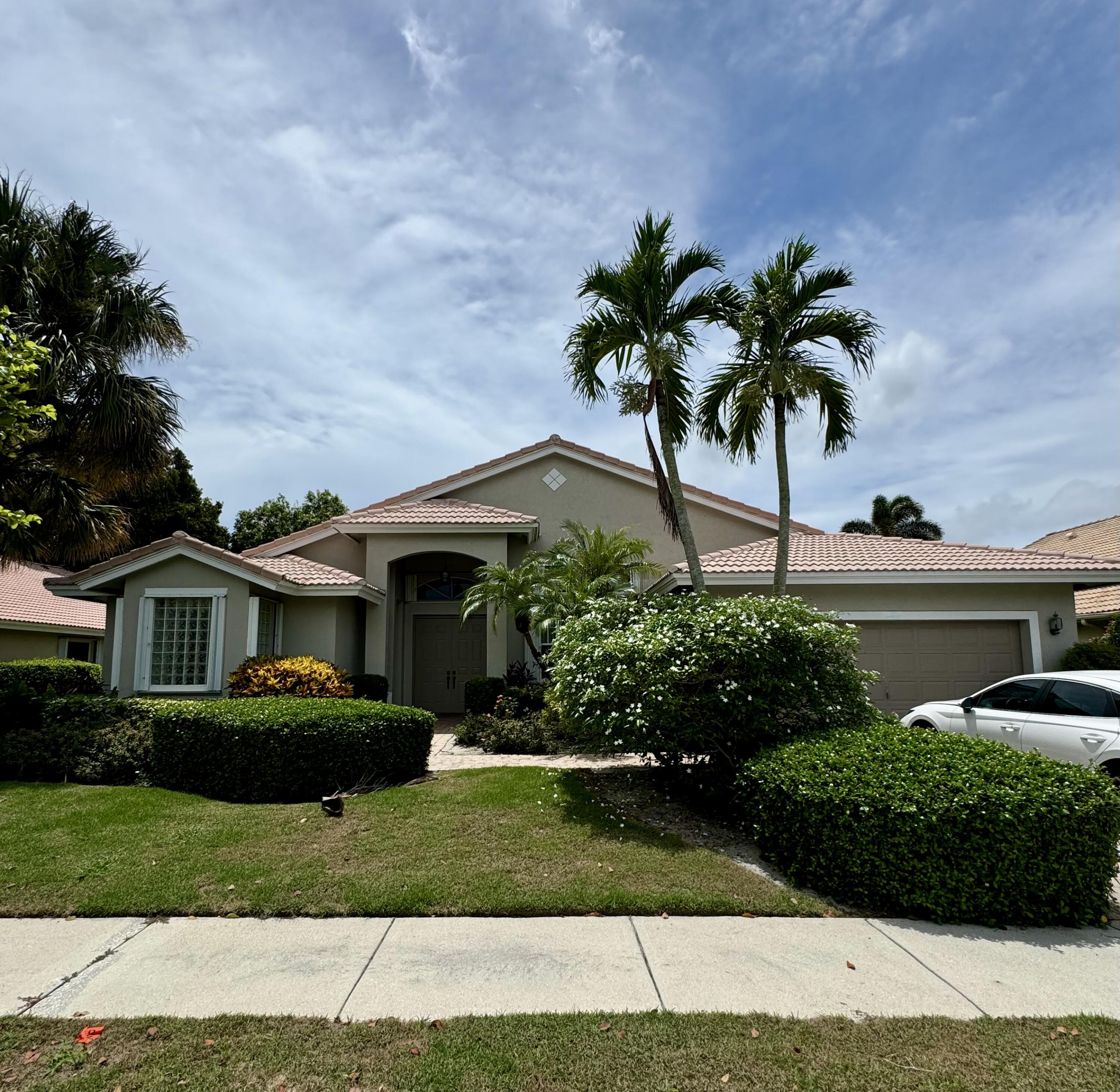 a front view of a house with a garden