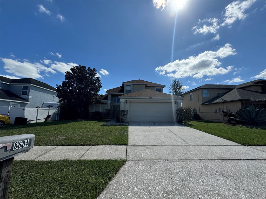 a front view of a house with a yard and a garage