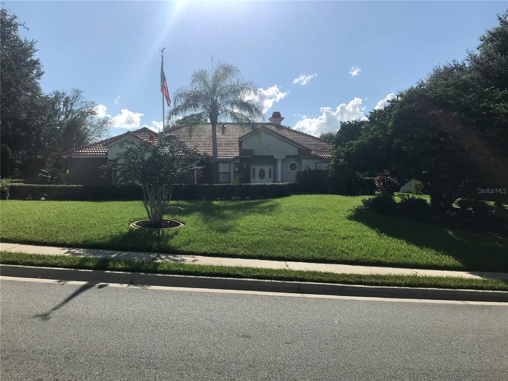 a front view of a house with a yard and a garage