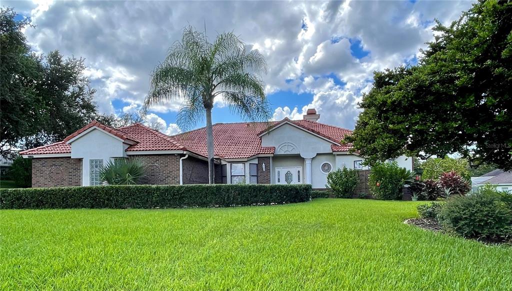 a front view of a house with a garden