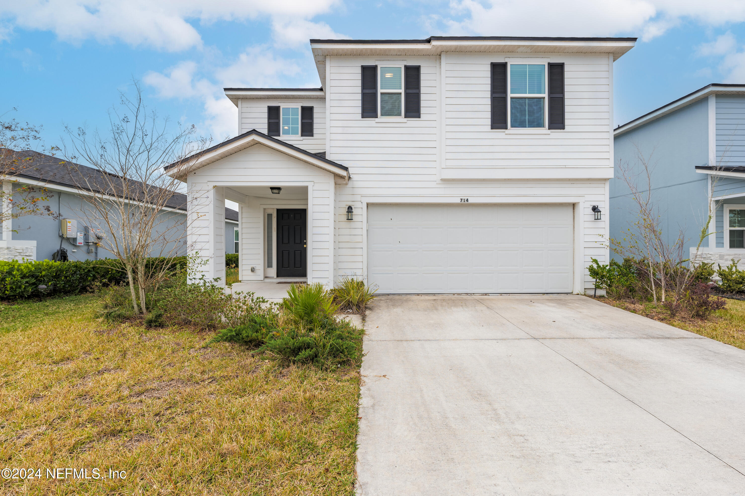 a front view of a house with garden