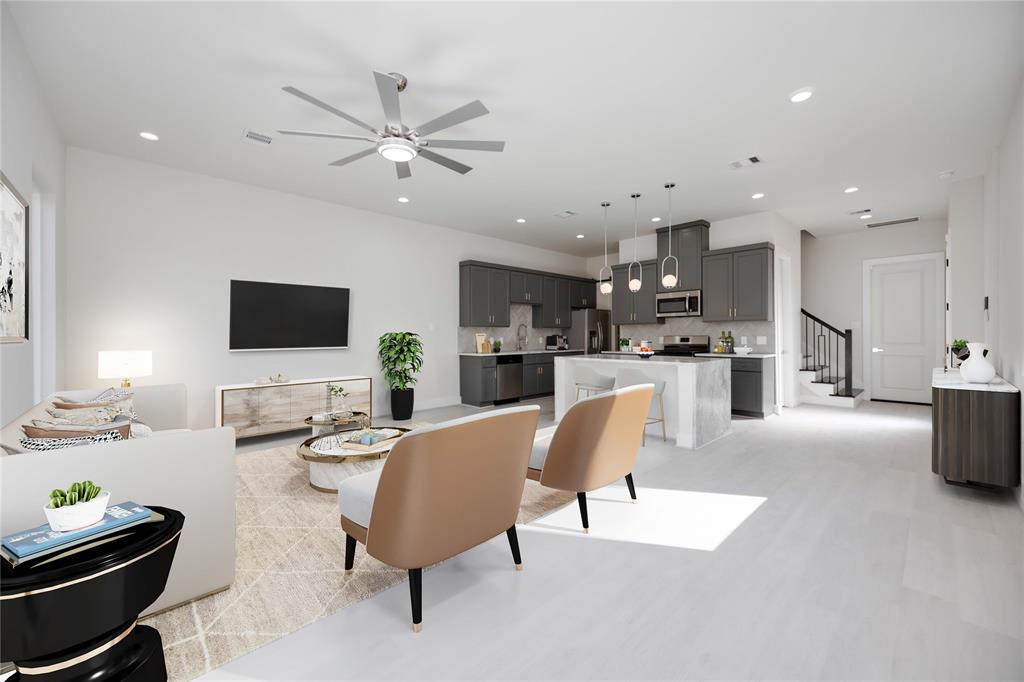 a living room with furniture kitchen view and a flat screen tv