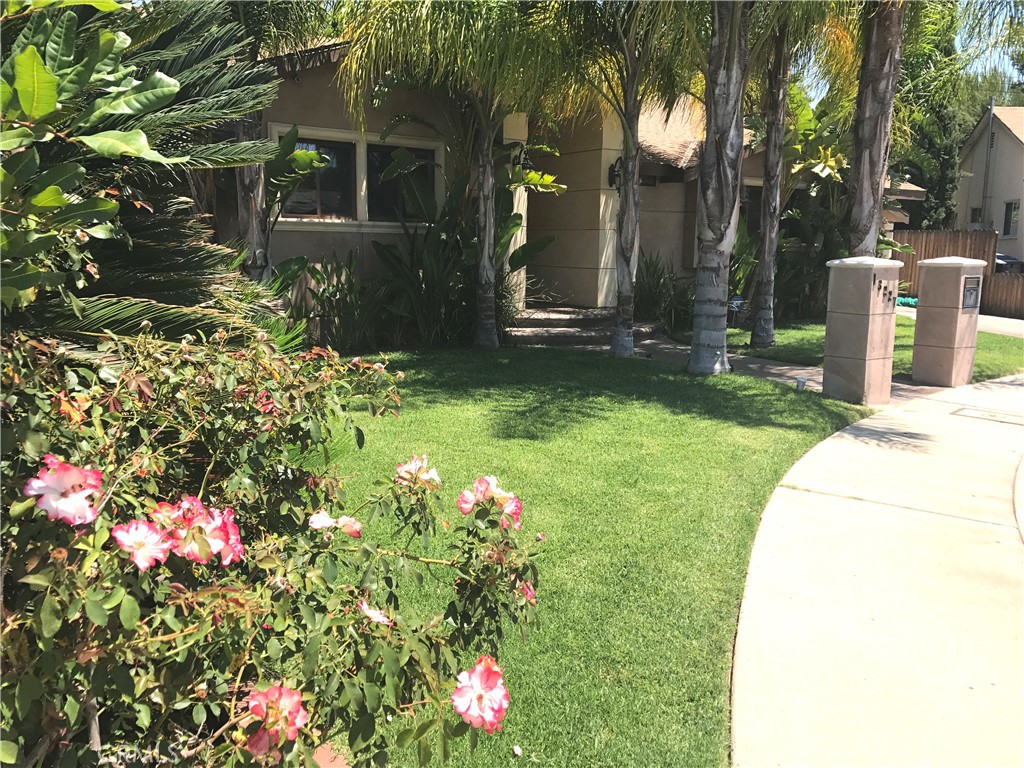 a view of a house with a yard and garden