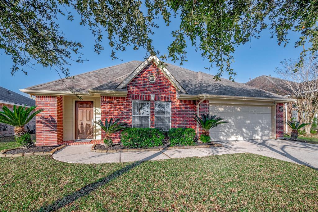 Charming brick home with excellent curb appeal, featuring a spacious two-car garage and beautifully landscaped front yard.