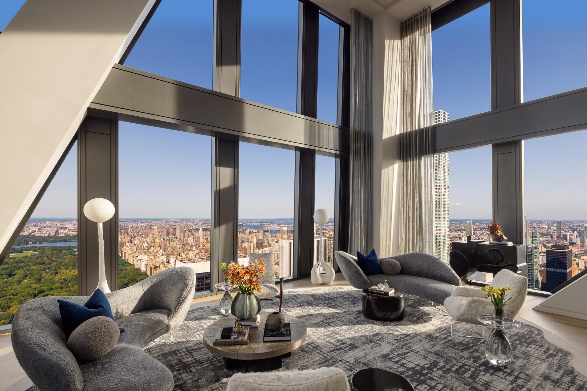 a living room filled with furniture and floor to ceiling windows