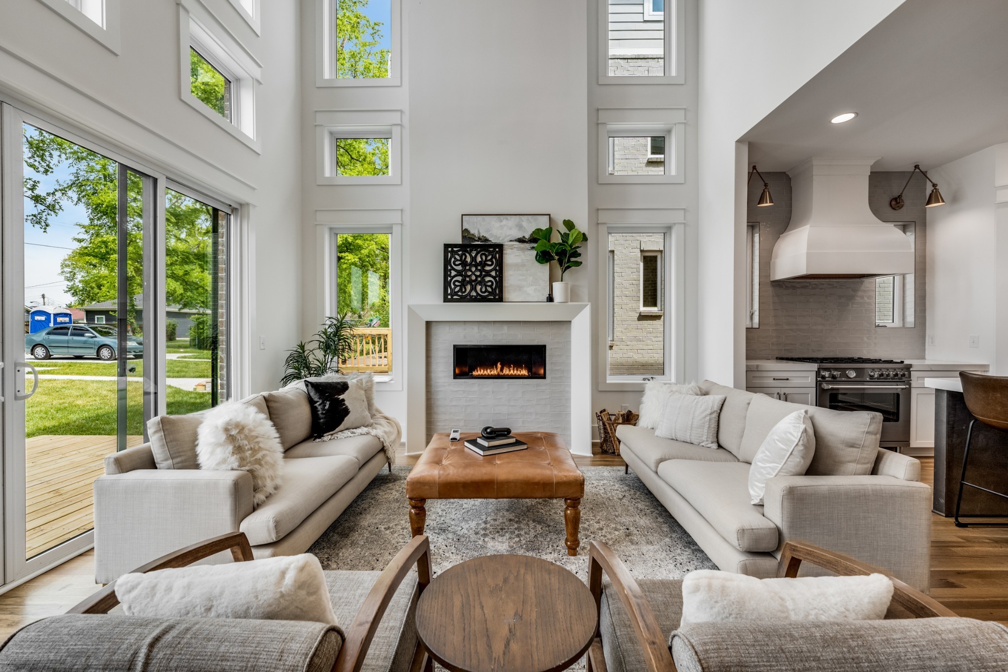 a living room with furniture fireplace and a large window