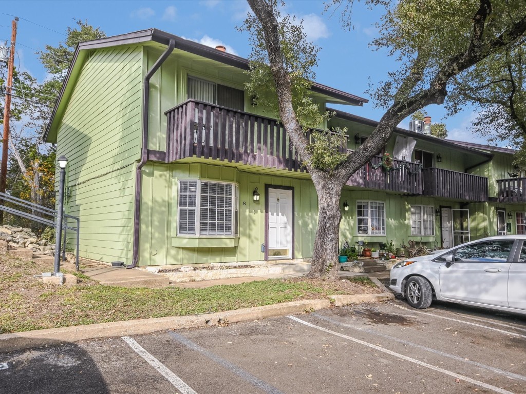 a view of a car park in front of a house