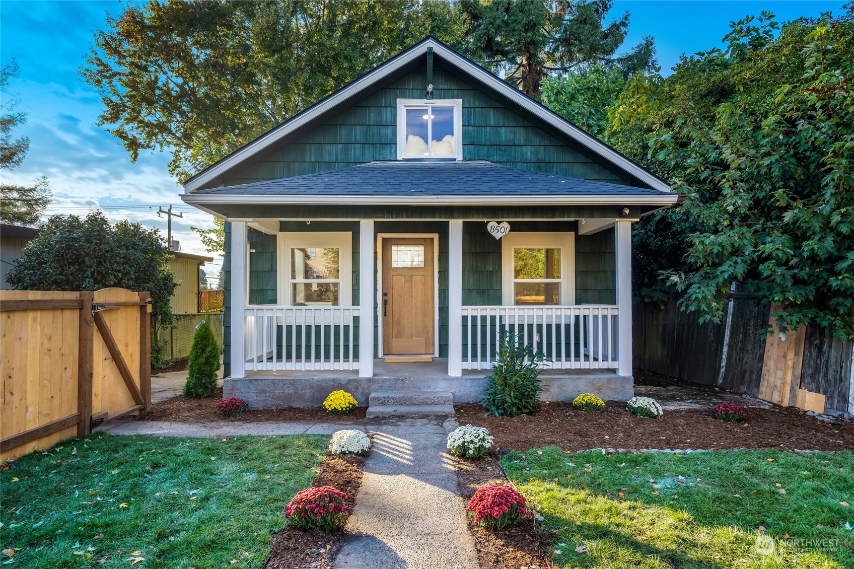 a view of a house with a yard and a garden