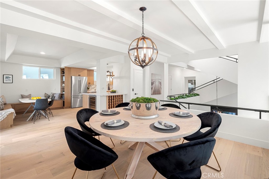 a view of a dining room with furniture a chandelier and wooden floor