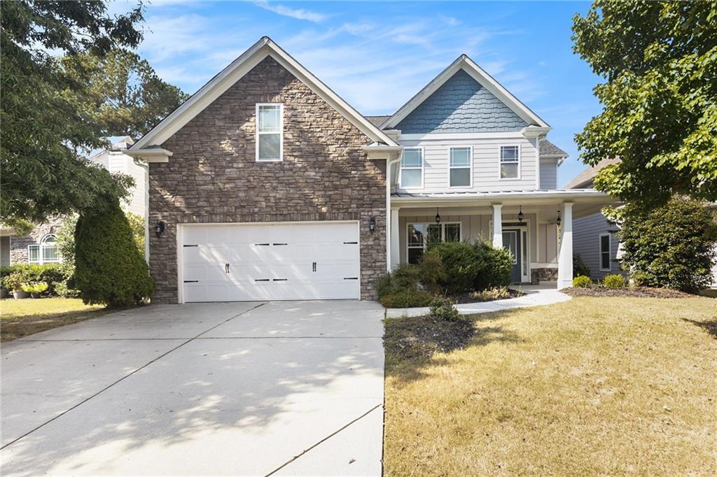 a front view of a house with a yard and garage