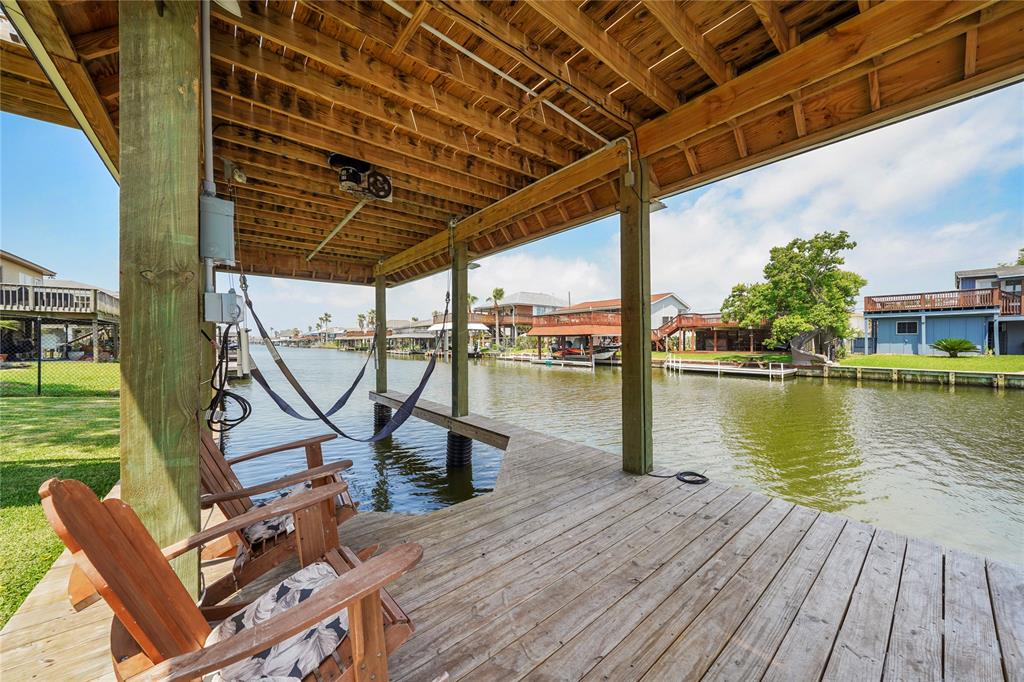 a view of a lake with couches chairs and wooden floor