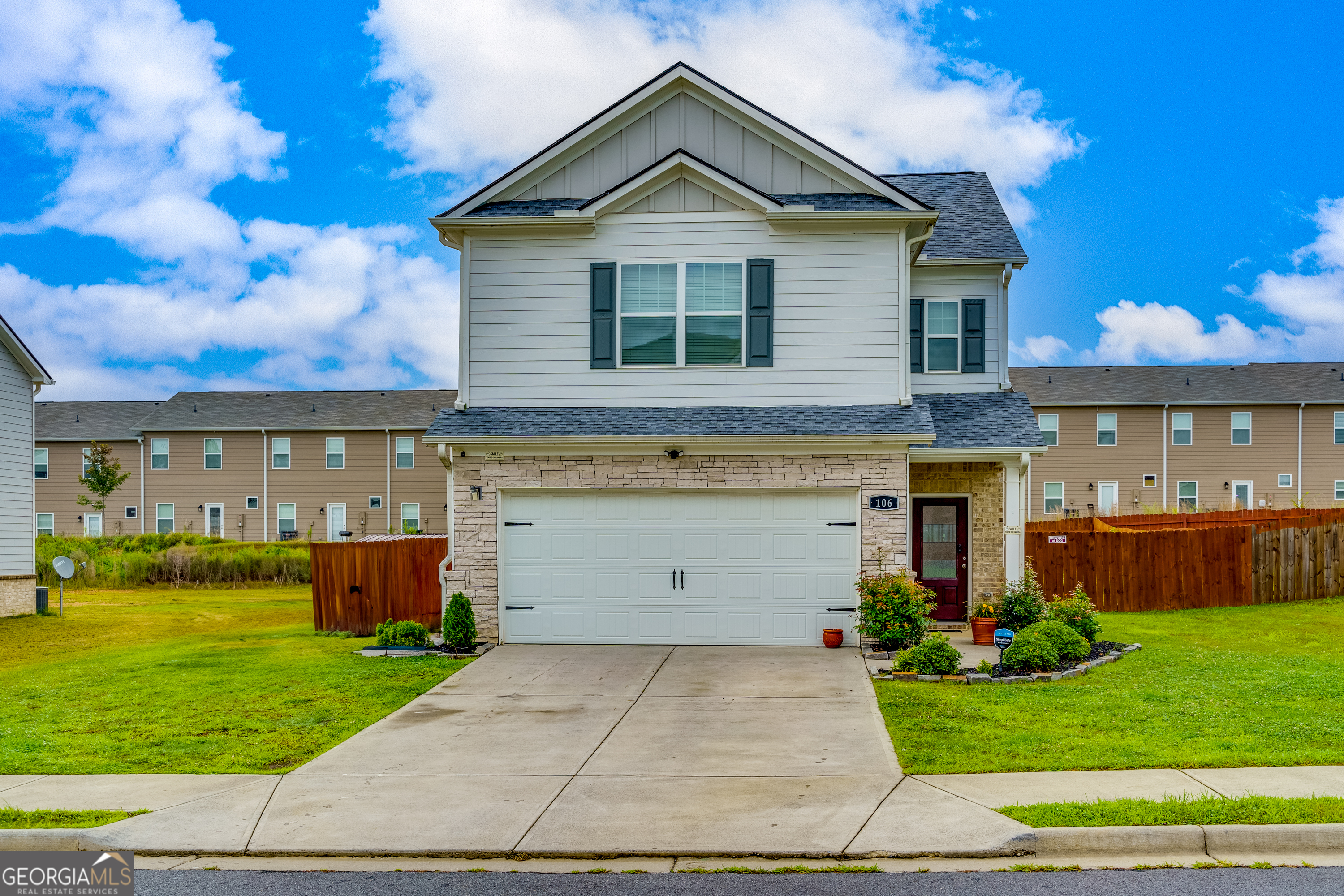 a front view of a house with a yard and garage